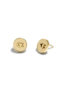 Boucles d'oreilles clous en ton or avec un design circulaire présentant un logo en relief C proéminent à l'avant. Surface lisse et brillante. Tige en métal simple.
