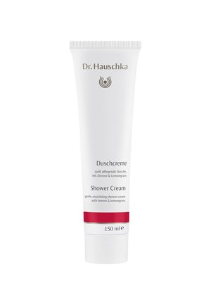 Tube souple blanche avec une bande d'accent rouge, étiquetée "Crème de Douche" avec des détails en or et noir, indiquant des ingrédients de citron et de citronnelle.