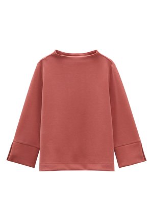 Felpa rosa con collo alto e maniche larghe, dotata di fessure laterali nei polsi per una maggiore ventilazione e un dettaglio di design.