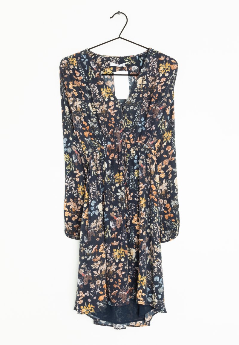 Robe à fleurs sombres à manches longues avec taille froncée et encolure en V, suspendue à un cintre en fil noir sur fond blanc.