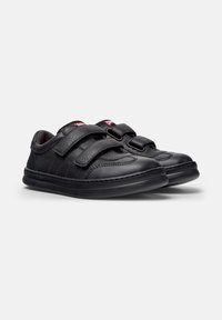 Chaussures noires avec un design en cuir texturé et synthétique, dotées de deux bandes auto-agrippantes, d'un bout rond et d'une semelle rembourrée.