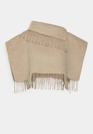Beige ullponcho med fransdetaljer vid fållen, med en enkel rektangulär form och en mjuk, texturerad yta.