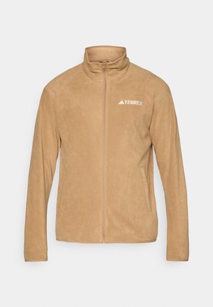 Beige Fleecejacke mit Stehkragen, durchgehendem Reißverschluss und zwei Seitentaschen. Besitzt ein weißes "TERREX"-Logo auf der linken Brust. Glatte Textur.