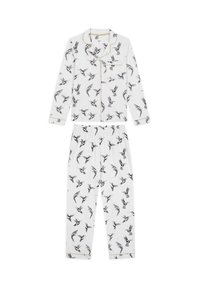 White pajama set with black bird prints. Long-sleeve top features a collar and gold piping; pants have an elastic waistband.