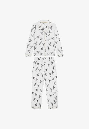White pajama set with black bird prints. Long-sleeve top features a collar and gold piping; pants have an elastic waistband.