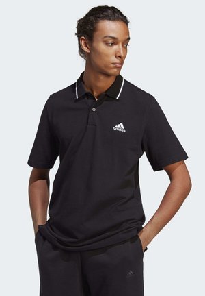 Polo nero con cuciture bianche a contrasto sul colletto, dotato di una chiusura a tre bottoni e del logo Adidas sul petto sinistro.
