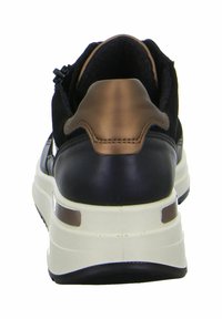 Black leather and suede sneaker with a metallic bronze accent on the heel, featuring a chunky white sole and textured back panel.