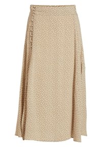 Jupe beige avec un motif à pois blancs, fabriquée dans un tissu léger. Présente une fente sur le côté et des détails de boutons le long de la taille.