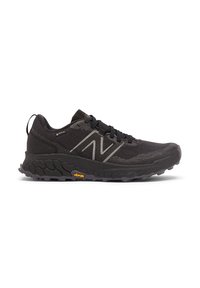 Black athletic shoe with textured sole, breathable mesh upper, Vibram outsole, Gore-Tex label, and reflective "N" logo on side.