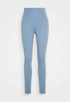 Blauwe legging met hoge tailleband, gemaakt van rekbare stof. Heeft een naadloos ontwerp en contrasterende stiksels langs de zijkanten.