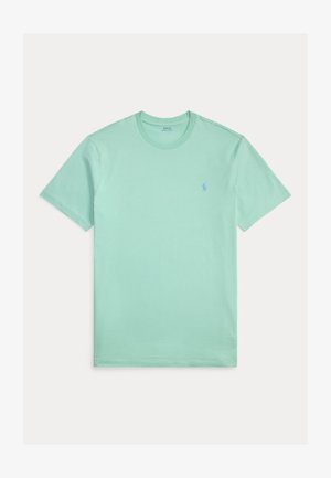 Heleroheline puuvillane T-särk, millel on ümarsärk kaelus ja lühikesed varrukad; vasakul rinnal on väike sinine tikitud logo.