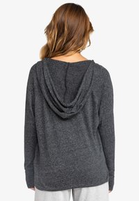 Dark gray hooded sweatshirt with a relaxed fit, textured fabric, and a draped back design. Features long sleeves and a simple neckline.