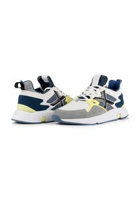 Baskets de sport présentant un mélange de matériaux blancs, marins et gris, avec des accents jaunes, un mesh texturé et une semelle souple.