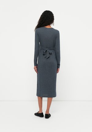 Gray ribbed knit dress with long sleeves, a fitted silhouette, and a waist tie at the back. Mid-calf length, soft texture.
