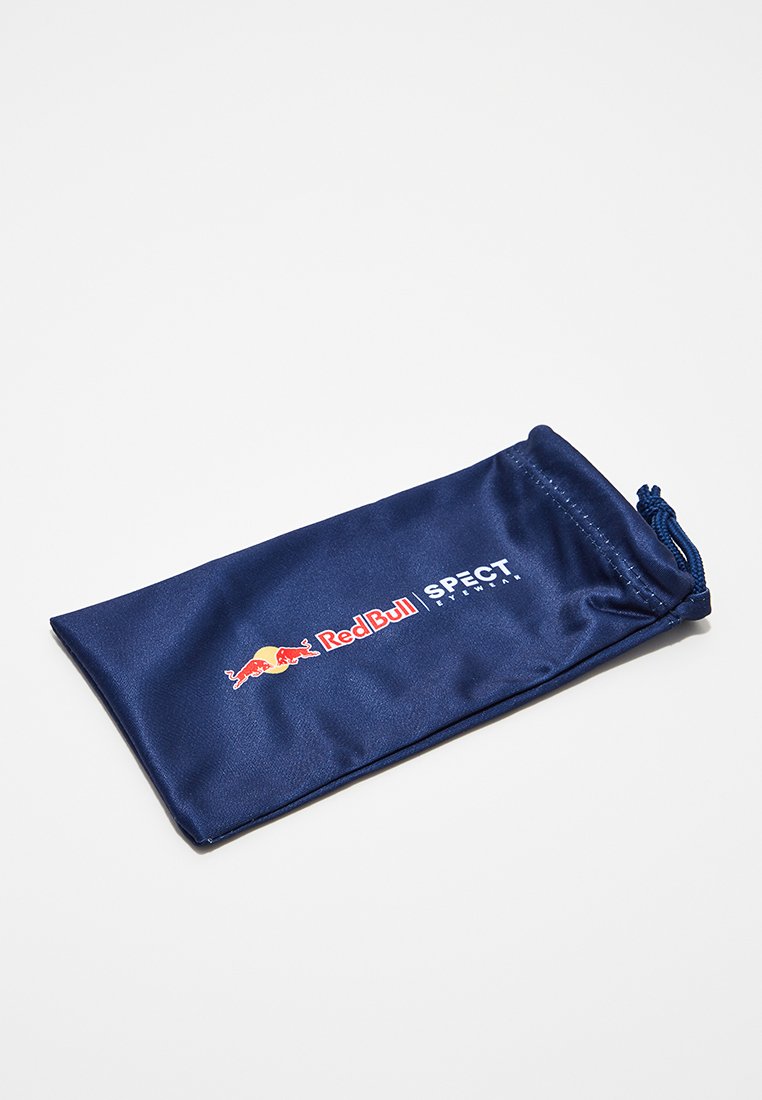 Granatowa torba na sznurku z miękkiego materiału, z logo Red Bull oraz tekstem "SPECT" nadrukowanym na biało. Gładka faktura, prostokątny kształt.