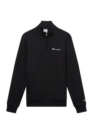Schwarze Baumwolljacke mit Reißverschluss. Sie hat einen hohen Kragen, lange Ärmel, Fronttaschen und ein kleines weißes Logo auf der Brust.