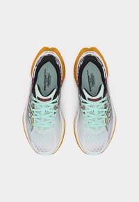 Φωτεινά μπλε και λευκά παπούτσια τρεξίματος με πορτοκαλί σόλες, σχέδια κορδονιών σε ανοιχτό γαλάζιο, πάτους "Endorphin Speedroll" και ετικέτα "Tokyo" στη γλώσσα.