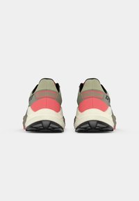 Αθλητικά παπούτσια με σχέδιο σε μπεζ και κοραλλί απόχρωση, με υφή στην επάνω πλευρά, μαύρες λεπτομέρειες και λευκή σόλα με ανάγλυφη επιφάνεια.