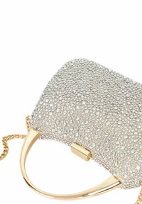 Clutch bag covered in silver rhinestones, featuring a curved gold handle and a chain strap. Textured surface with a glossy finish.