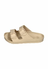 Beige sandals with two adjustable straps, made of smooth material, featuring a contoured footbed and textured outsole.