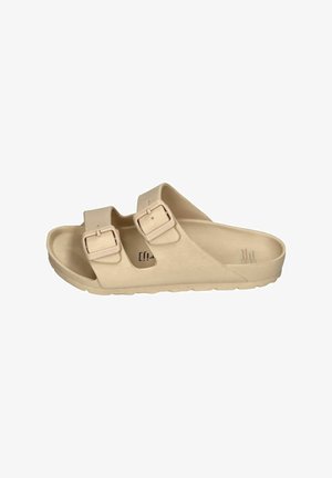 Beige sandals with two adjustable straps, made of smooth material, featuring a contoured footbed and textured outsole.