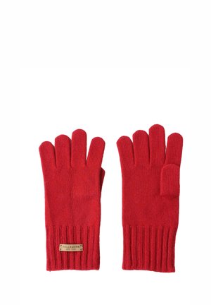 Guanti in lana rossa con polsini a coste, caratterizzati da un design senza dita. Un piccolo etichetta rettangolare è cucita al polso con i dettagli del marchio.