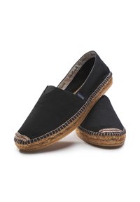 Black canvas espadrilles with braided jute soles, featuring a closed toe design and contrasting stitching along the edges.