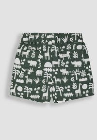 Shorts verts avec un motif d'animaux et de plantes blanches. Taille élastique avec deux poches arrière et un tissu doux et léger.