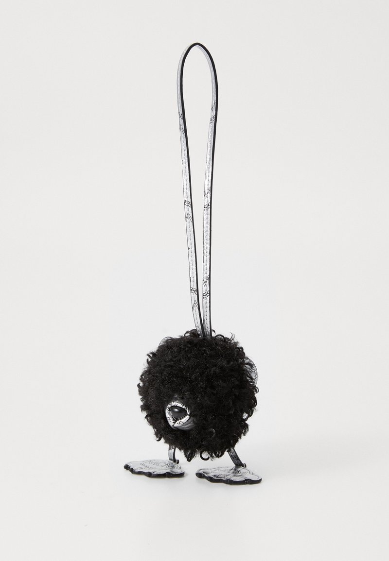 Black fluffy figurine with a round body and long ears, featuring metallic legs and detailed accents on the feet. Decorative eyes included.