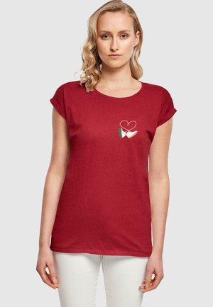 T-shirt rosso a maniche corte con design ricamato di un cuore e una mano nei colori della bandiera italiana. Materiale in cotone morbido, vestibilità rilassata.