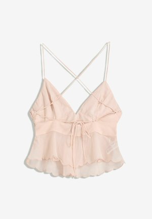 Light pink camisole with adjustable spaghetti straps, a fitted bodice, and a flared hem featuring a scalloped edge and tie detail.