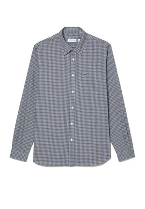 Chemise à manches longues à carreaux en marine et blanc, avec un col boutonné et un petit logo brodé sur la poitrine. Fabriquée en tissu.