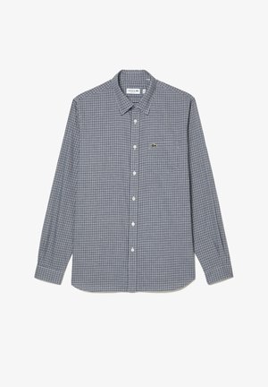 Camisa de cuadros de manga larga en azul marino y blanco, con un cuello abotonado y un pequeño logotipo bordado en el pecho. Hecha de tela.