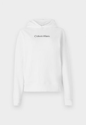 Balta medvilninė palaidinė su kapišonu, priekyje turi kengūrinę kišenę, ilgomis rankovėmis ir juodu „Calvin Klein“ logotipu krūtinėje.