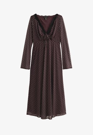 Vestito marrone a maniche lunghe con pois bianchi, scollo a V profondo rifinito con pizzo nero e un piccolo fiocco sul busto.