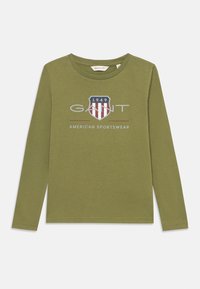 Langärmliges T-Shirt in Olivgrün aus Baumwolle. Mit einem Logo mit roten und weißen Streifen in einem Wappen-Design und dem Text "GANT AMERICAN SPORTSWEAR".
