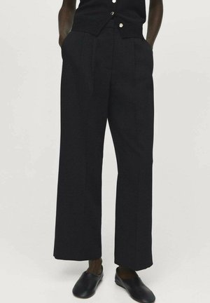 Black wide-leg trousers with a high waist, featuring neatly pressed pleats and side pockets, made from a smooth fabric.