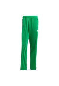 Green athletic pants made of lightweight fabric, featuring a tapered design, elastic waistband, and white side stripes with a logo.