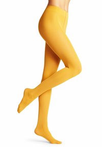 Collant gialli realizzati in materiale liscio e elastico, caratterizzati da un design senza cuciture e una forma aderente, che si estendono dalla vita alla caviglia.