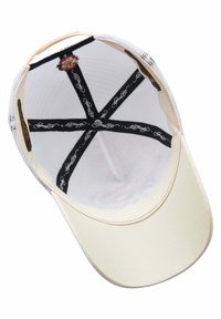 Cream baseball cap with a solid front, mesh back, black inner lining featuring text, and a floral design at the crown.