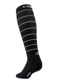 Knee-high black compression sock with white horizontal stripes, made of a textured fabric, featuring logo and reinforced toe and heel areas.