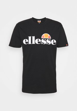 Schwarzes Baumwoll-T-Shirt mit einem großen weißen "ellesse"-Logo und einem orange-gelben Sonnensymbol über dem Text. Kurze Ärmel, normale Passform.
