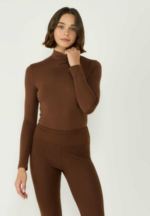 Brown long-sleeve top with a high collar paired with matching brown fitted leggings, made from a smooth, stretchy fabric.