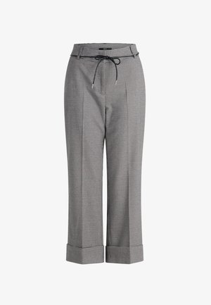 Checkered pants in black and white, featuring a drawstring waist, wide legs, and folded cuffs. Made from a lightweight fabric.