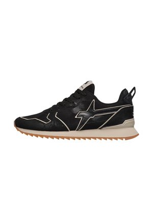 Sort og beige atletiksneaker med snørelukning foran, stjernedesign på siden og rillede gummisål, vist fra yderside.