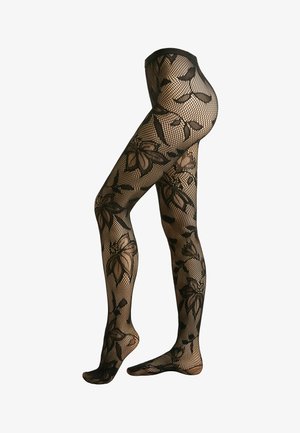 Black floral patterned fishnet tights on legs, showing ornate large flower and leaf designs from waist to feet.