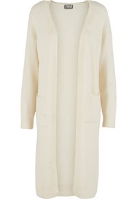 Garš, atvērtā priekša kardigans no mīksta krēmkrāsas auduma. Ir divas priekšējās kabatas un ribaina apdare pie aprocēm. Vienkāršs, minimālistisks dizains.