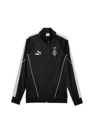 Giacca sportiva nera con zip, piping bianco, strisce fantasia verde menta sulle maniche, logo Puma, scritta "KING" e stemma calcistico del Borussia Mönchengladbach.