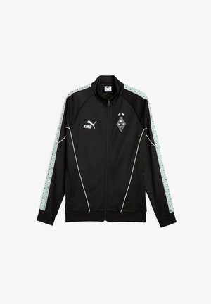 Schwarze Sportjacke mit Reißverschluss, weißen Paspeln, mintgrünen gemusterten Streifen an den Ärmeln, Puma-Logo, Schriftzug „KING“ und Borussia Mönchengladbach Fußballwappen.