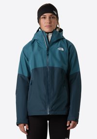 Teal and navy waterproof jacket with a hood, zippered front, and two side pockets. Features a logo on the chest and contrasting color panels.